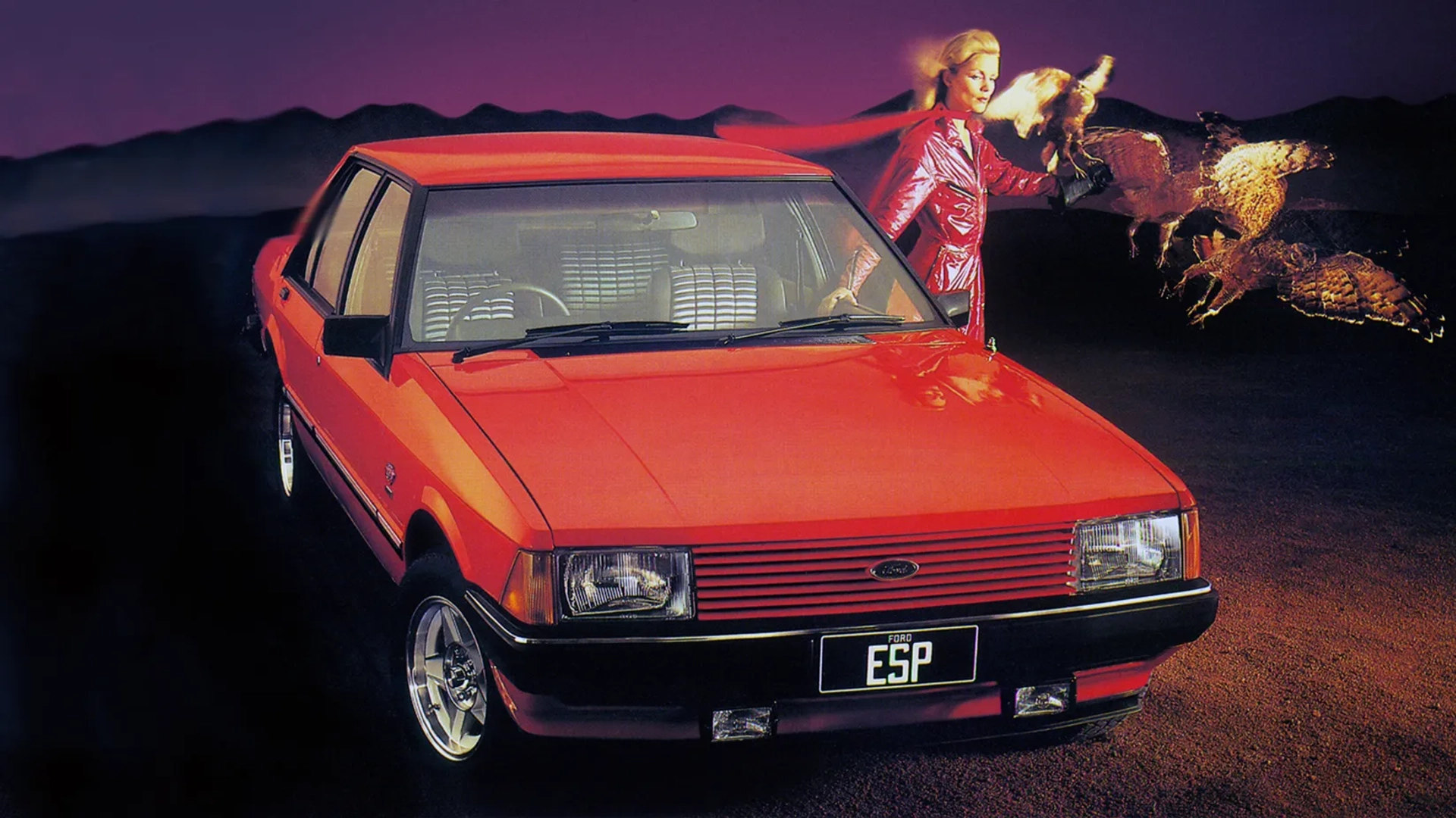 A red Ford Falcon ESP, 1982 print advertisement image. Also features a female model and a falcon.