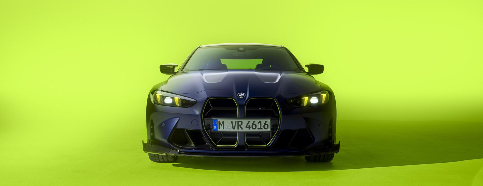 BMW M4 CS Edition front end, with a green background.